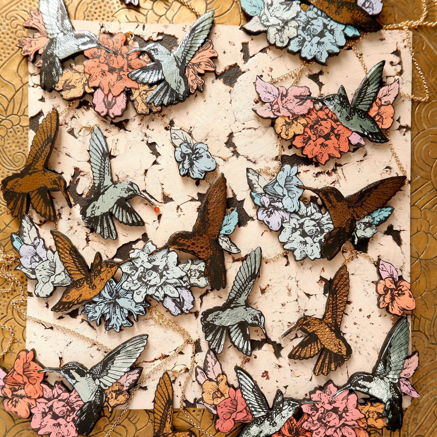 Hummingbird Necklaces in collaged screen-pinted coloured leather, on gold plated chain.