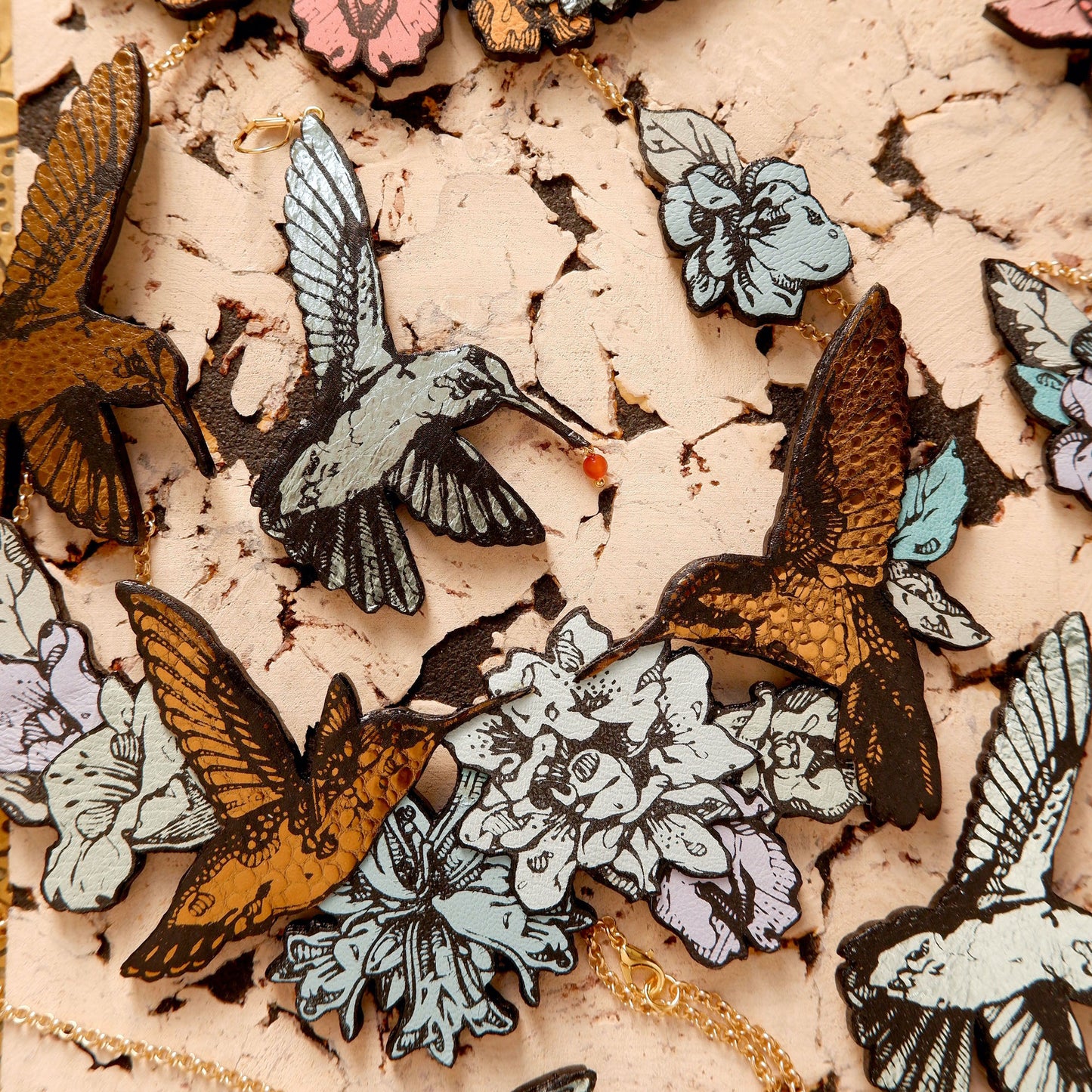 Hummingbird Necklaces in collaged screen-pinted coloured leather, on gold plated chain.