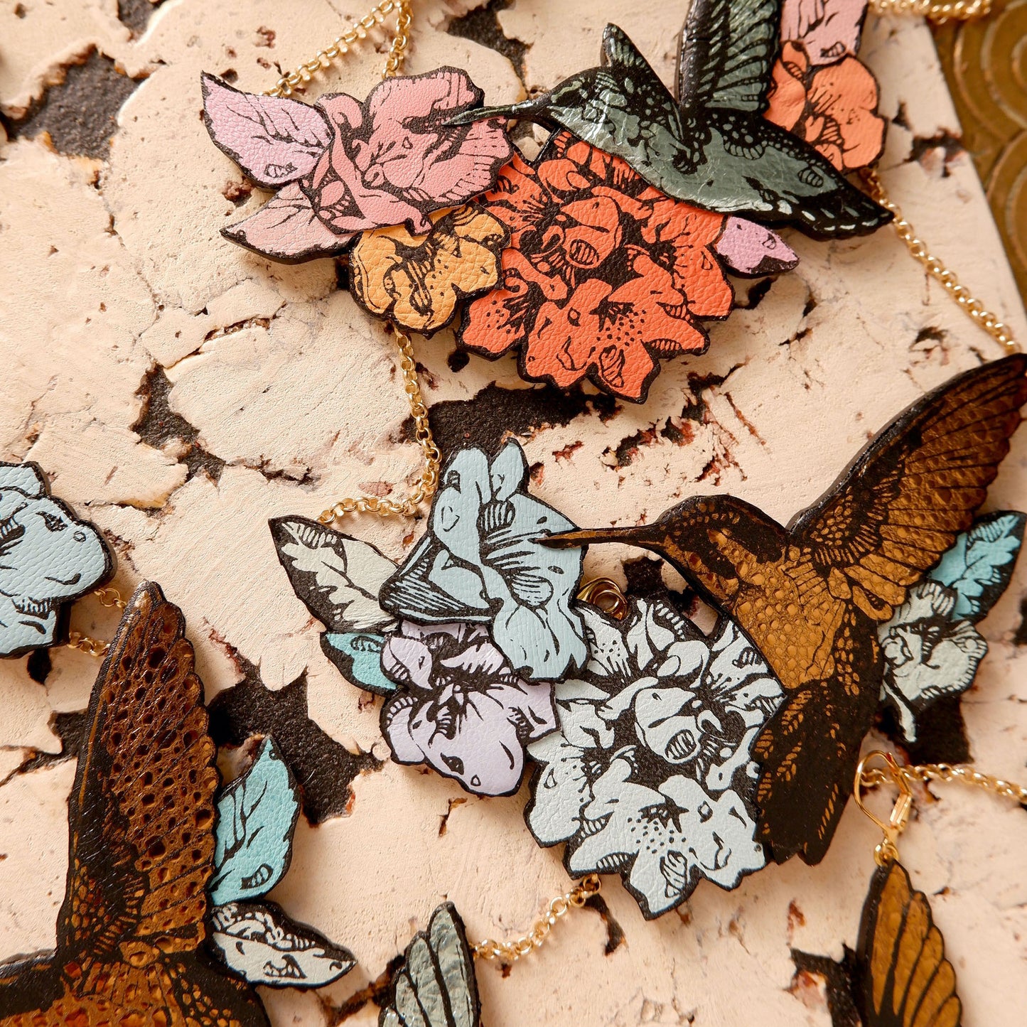 Hummingbird Necklaces in collaged screen-pinted coloured leather, on gold plated chain.