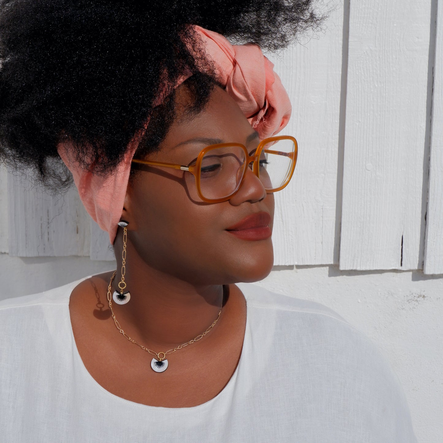 long chain drop earrings with black spiky palm design, and matching pendant, on mother of pearl, in oyster shell