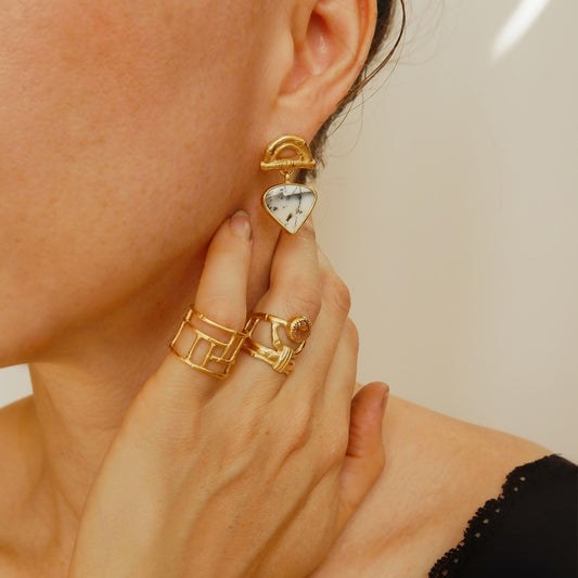 Gold Vermeil stud earrings featuring bamboo sunrise arch design, with gemstone drop pendants in white & grey Dendrite Opal, shown on model , with gold bamboo rings