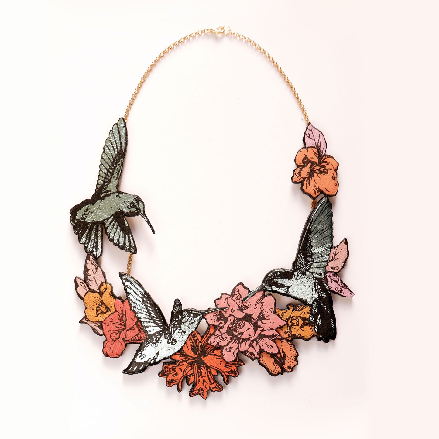 Hummingbird Necklace in collaged screen-printed coloured leather, on gold plated chain.