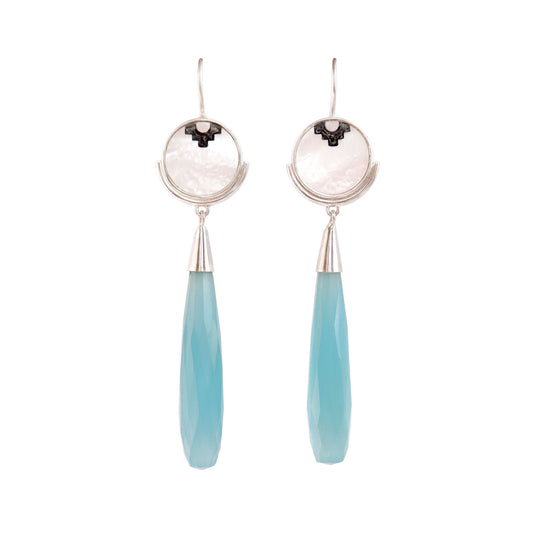 sterling silver earrings featuring mother of pearl discs, engraved with a blackened geometric steps design, and adorned with long blue faceted chalcedony gemstone drop pendants.