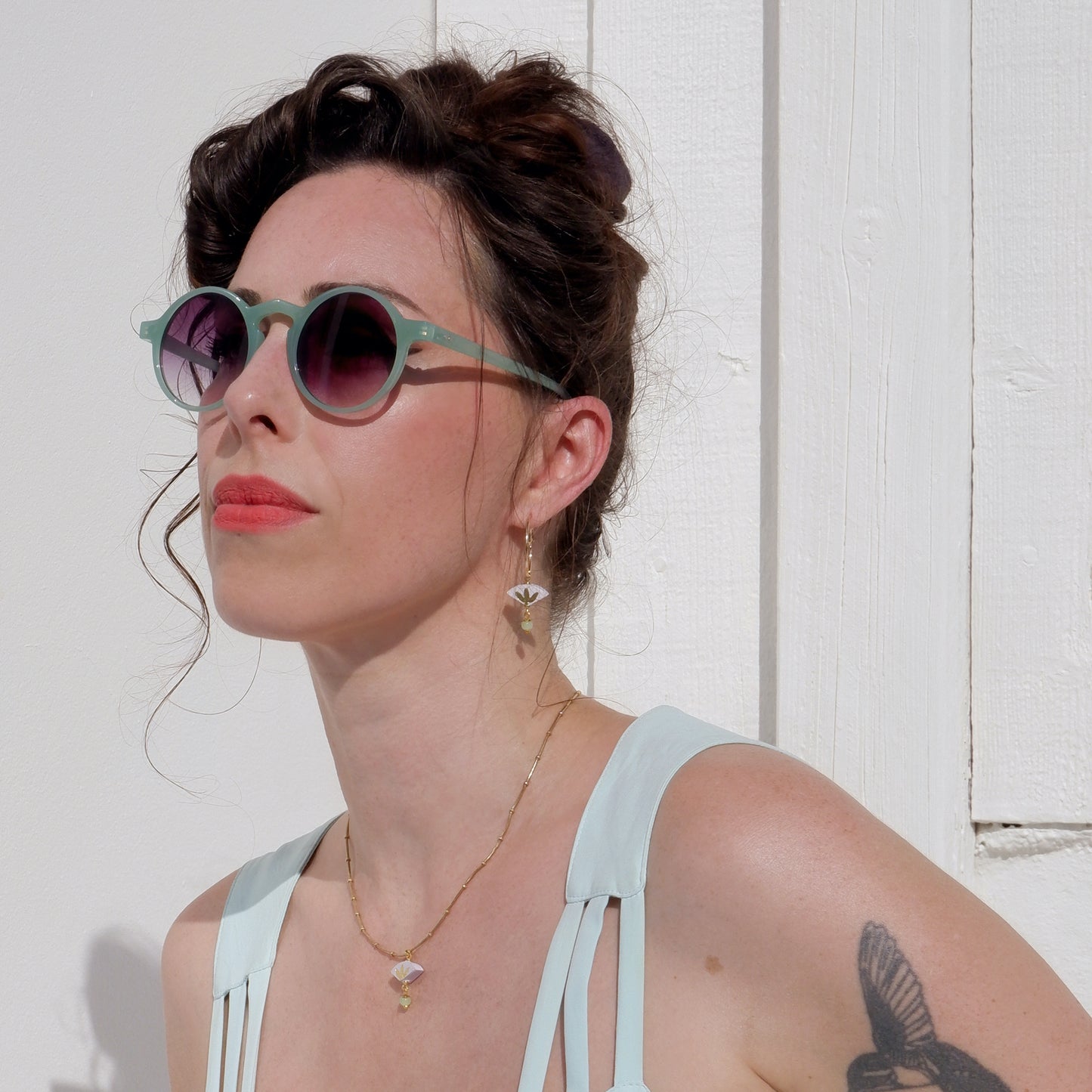 small leather fan earrings & pendant, with gold palm leaf print, and dangling beads, on model