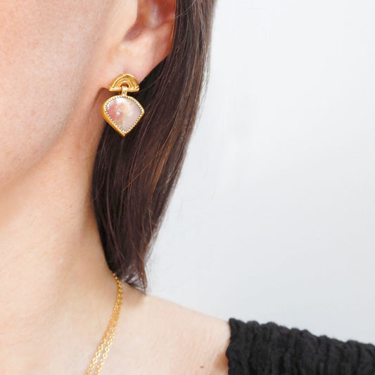 small stud earrings in gold vermeil, featuring triple arches of bamboo, hung with fan shaped pink opal gemstone charm pendants, set with gold teeth. Shown on model for scale.