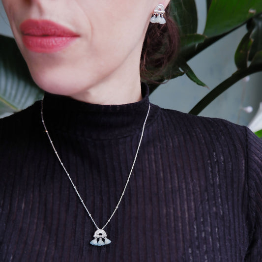 small stud earrings in Sterling Silver, featuring a triple arch of bamboo, hung with Pyramid Trillion Beads in Aquamarine, with matching pendant, on model