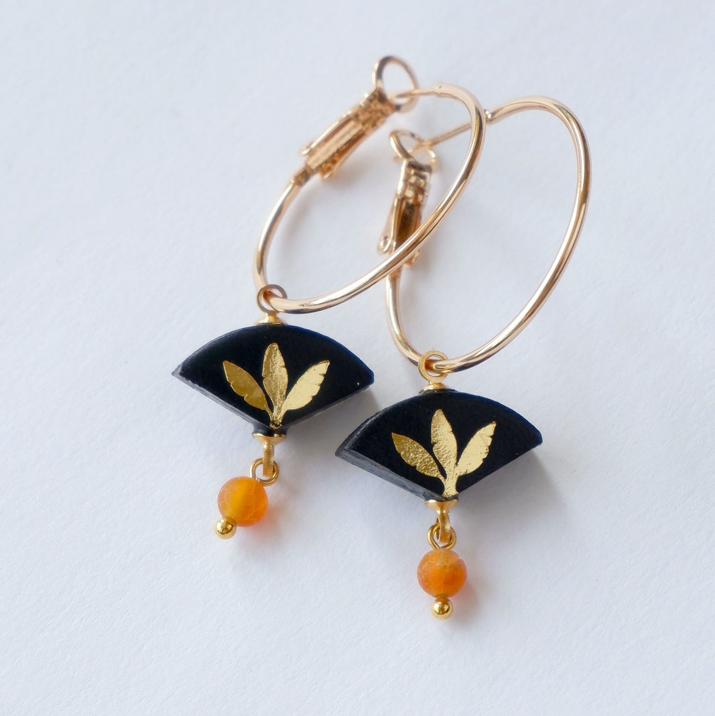 black & gold palm print leather gold hoop earrings with orange agate bead