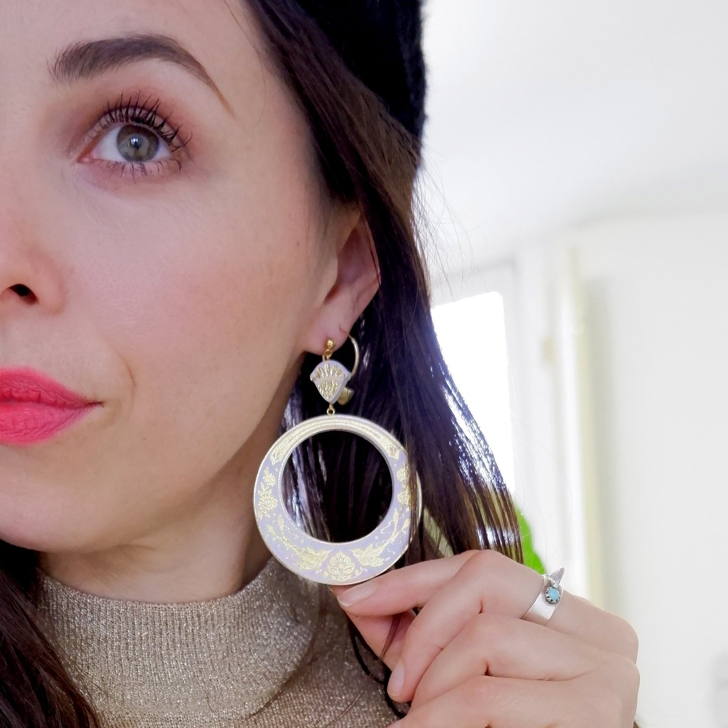 model wearing large pale lilac hoop earrings