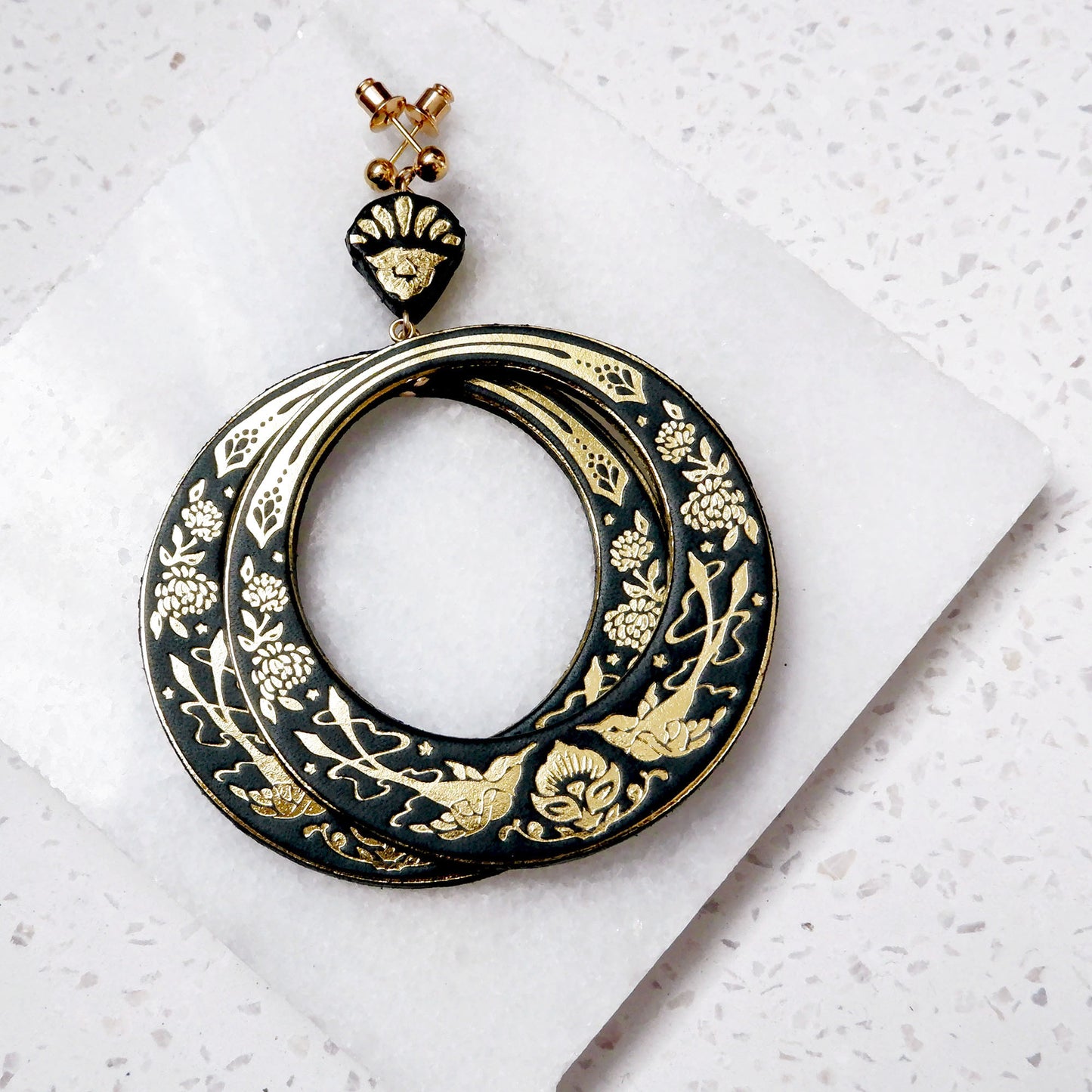 large hoops earring printed with birds & flowers in gold on black leather