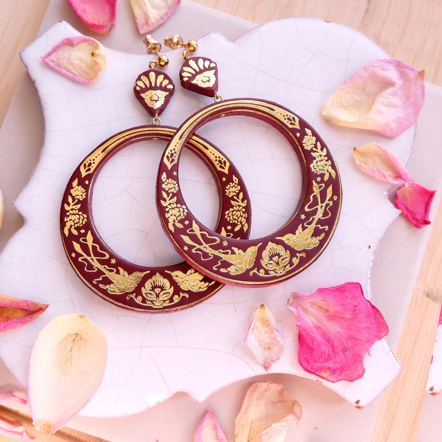 large hoops earring printed with birds & flowers in gold on ox blood leather