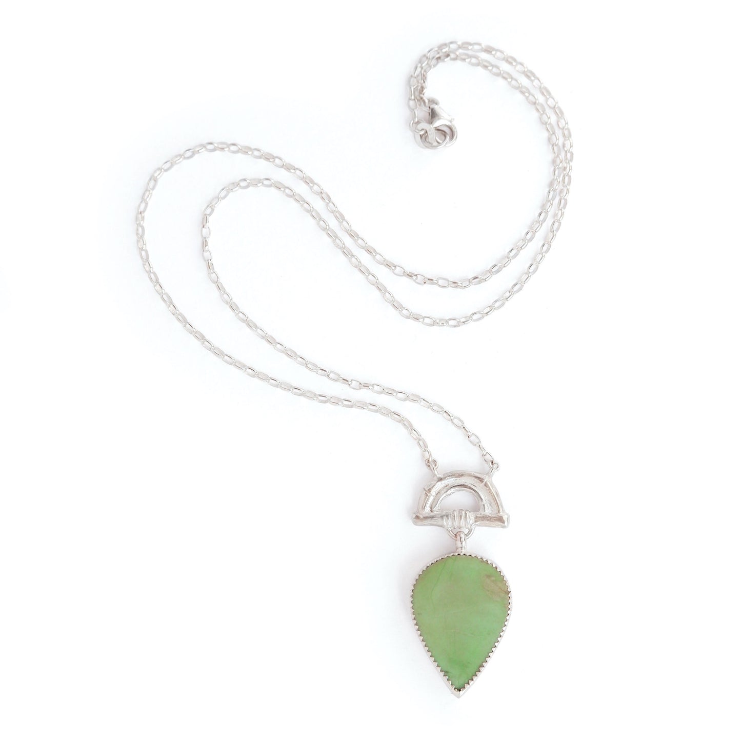 Pendant with pear shaped green turquoise gemstone hanging from Silver Bamboo Arch, on a silver chain. White Background