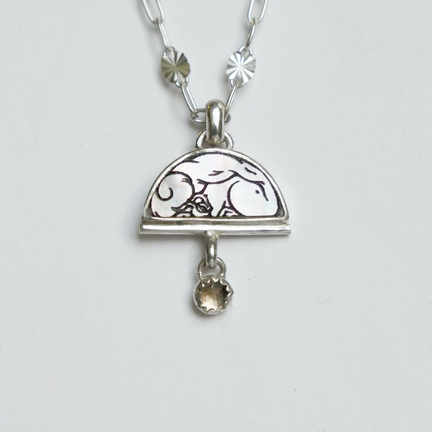 sterling silver half moon pendant, set with mother of pearl, engraved with squirrel illustration, and gemstone drops, on fine silver starburst chain