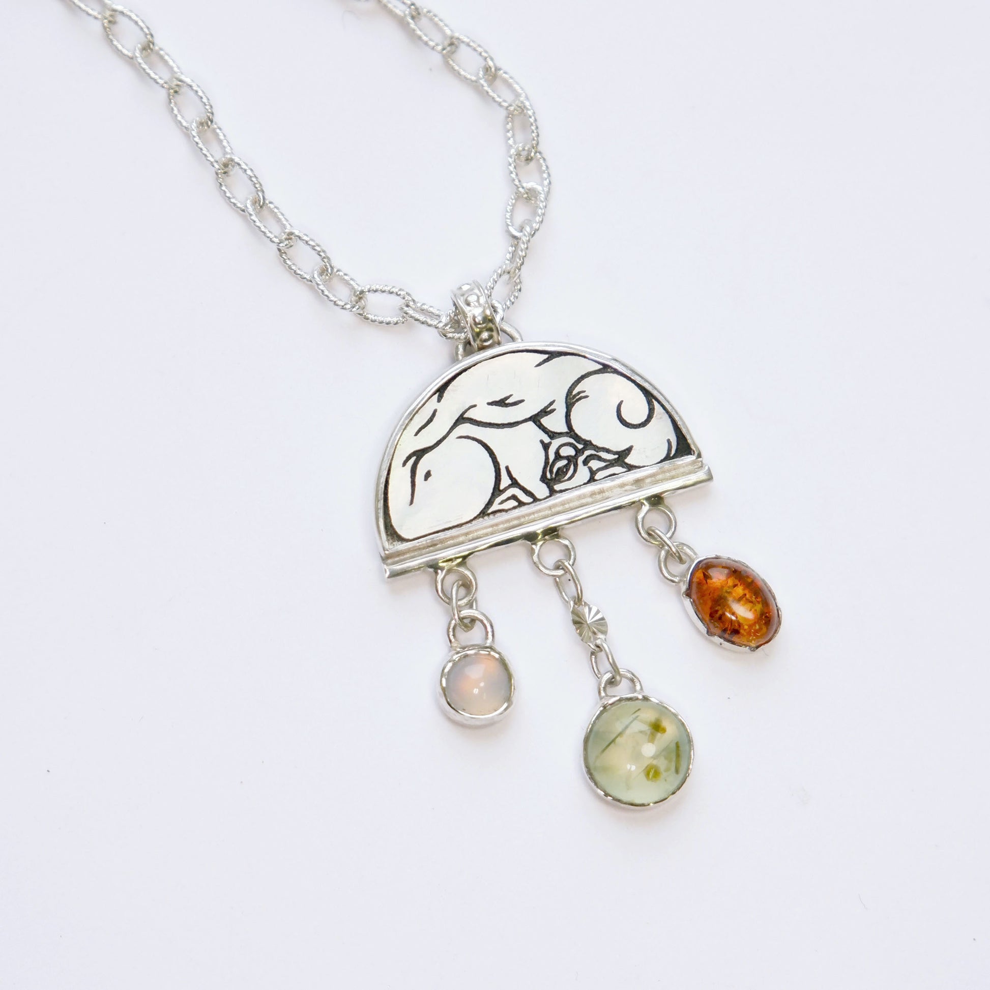 sterling silver half moon pendant necklace on chain, set with mother of pearl, engraved with squirrel illustration, and gemstone drops.