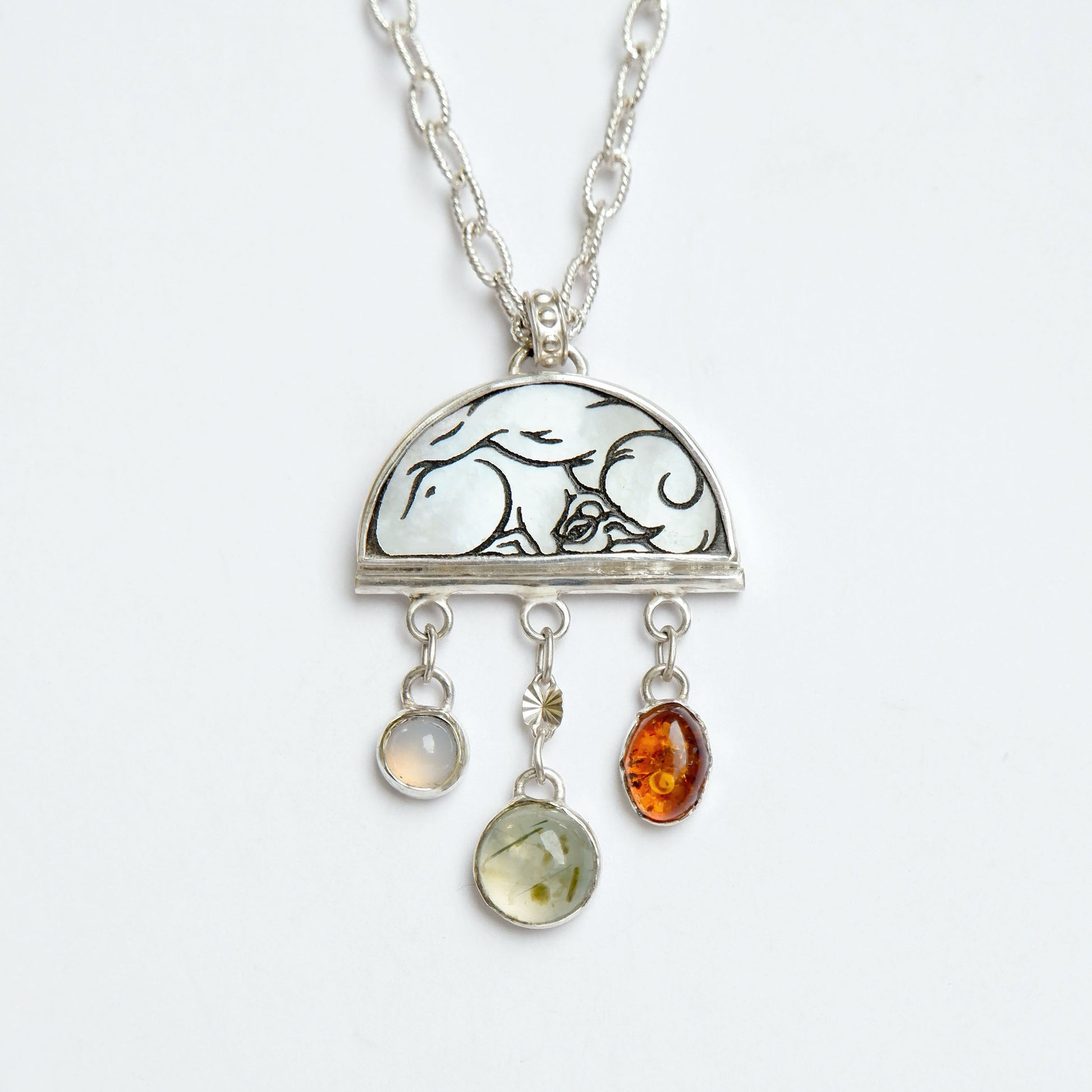 sterling silver half moon pendant necklace on chain, set with mother of pearl, engraved with squirrel illustration, and gemstone drops.