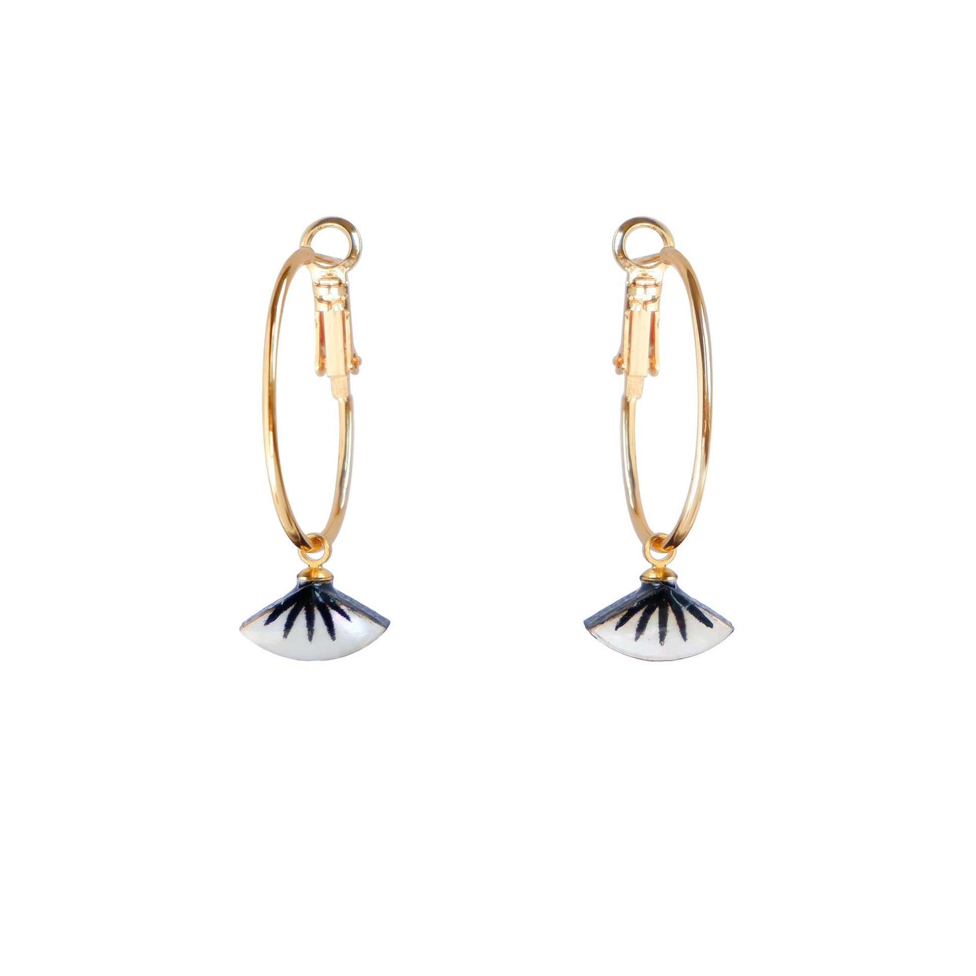 small gold hoop earrings with black spiky palm design on mother of pearl.