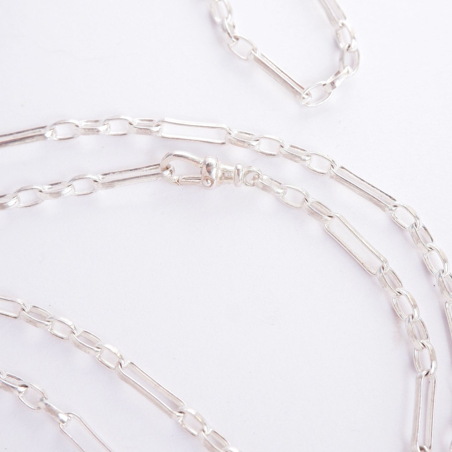 sterling silver chain on white background. close cropped photo showing clasp