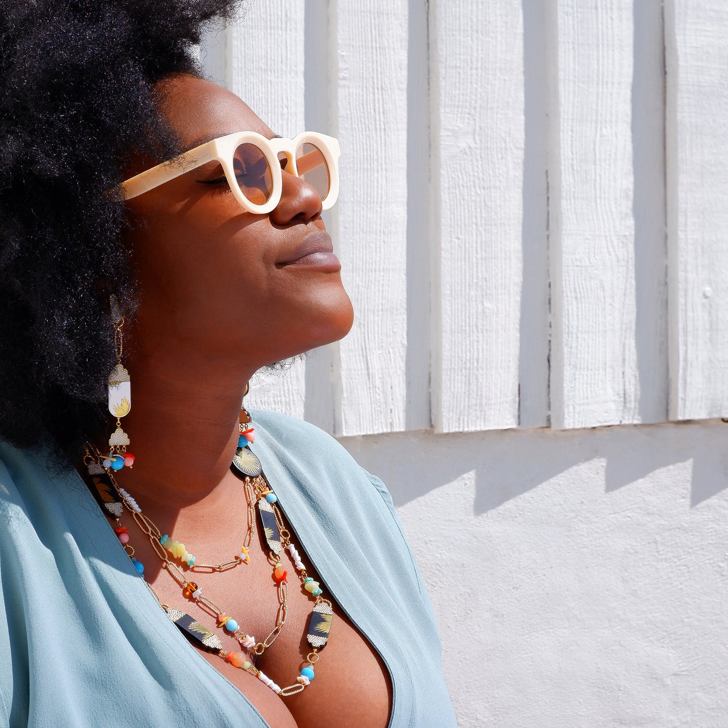 multi strand beaded chain necklace with palm-print leather, and matching drop earrings, on model