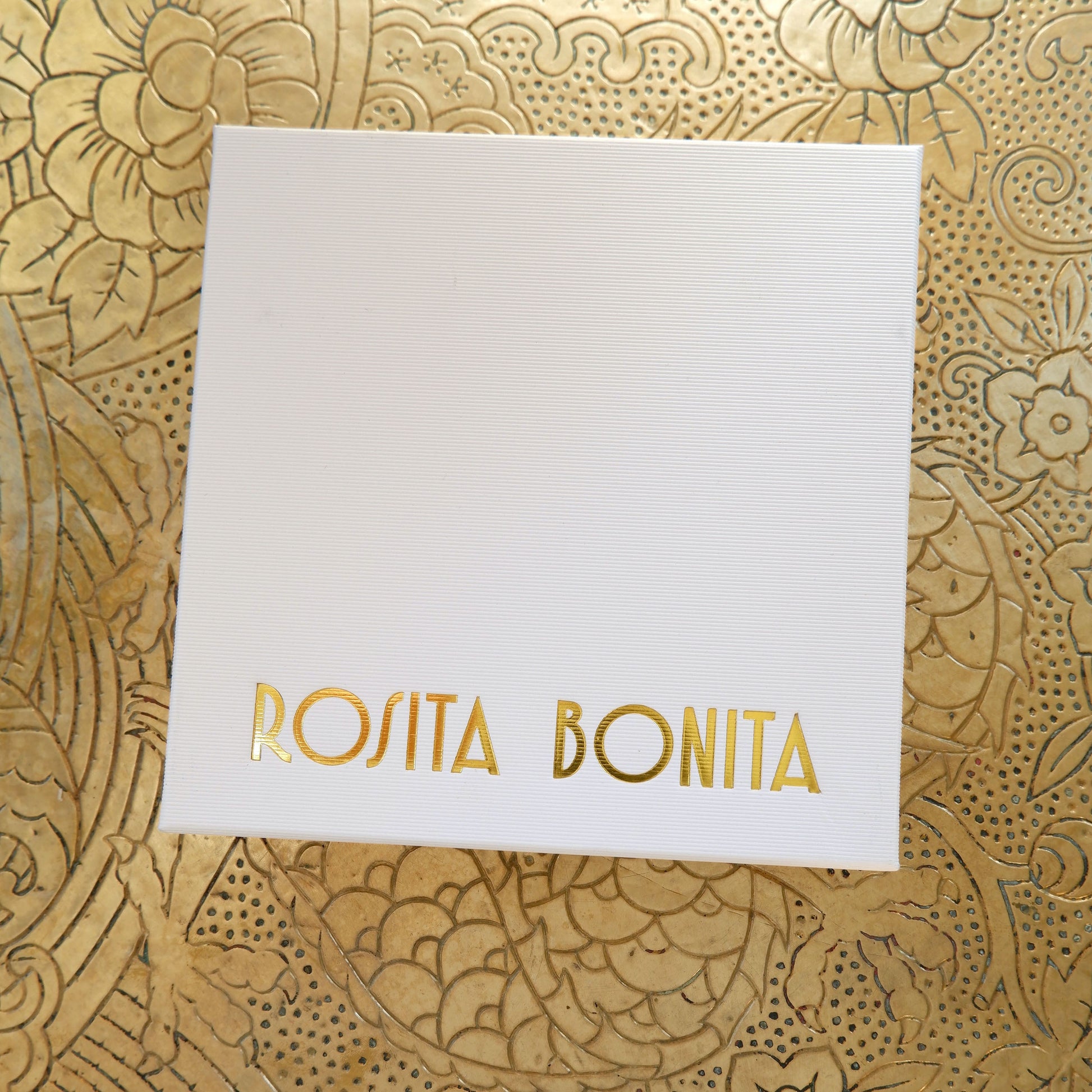 Large White finely ribbed cardboard jewellery box, with ROSITA  BONITA logo branding in Gold foil, on gold patterned background