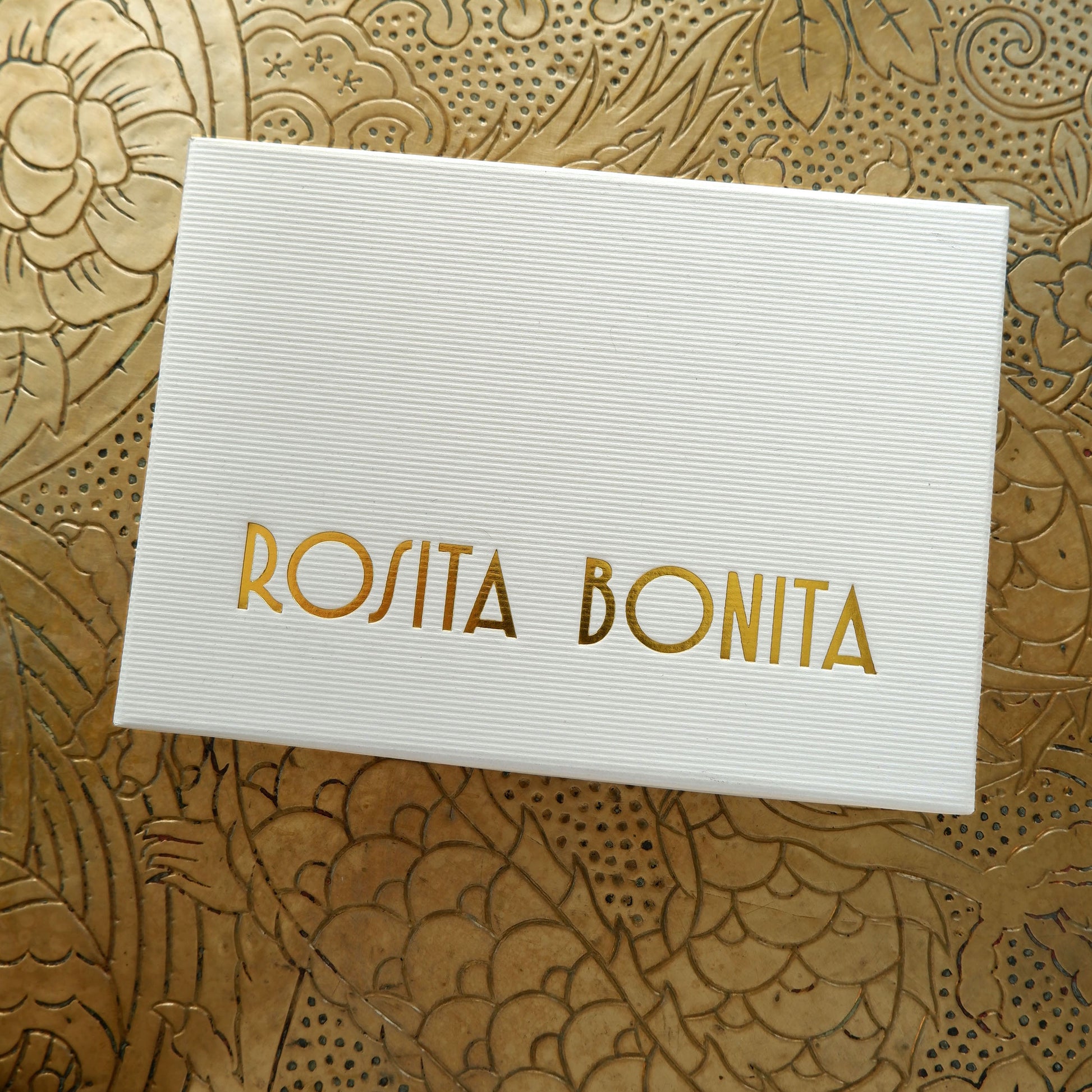 Large White finely ribbed cardboard jewellery box, with ROSITA  BONITA logo branding in Gold foil, on gold patterned background