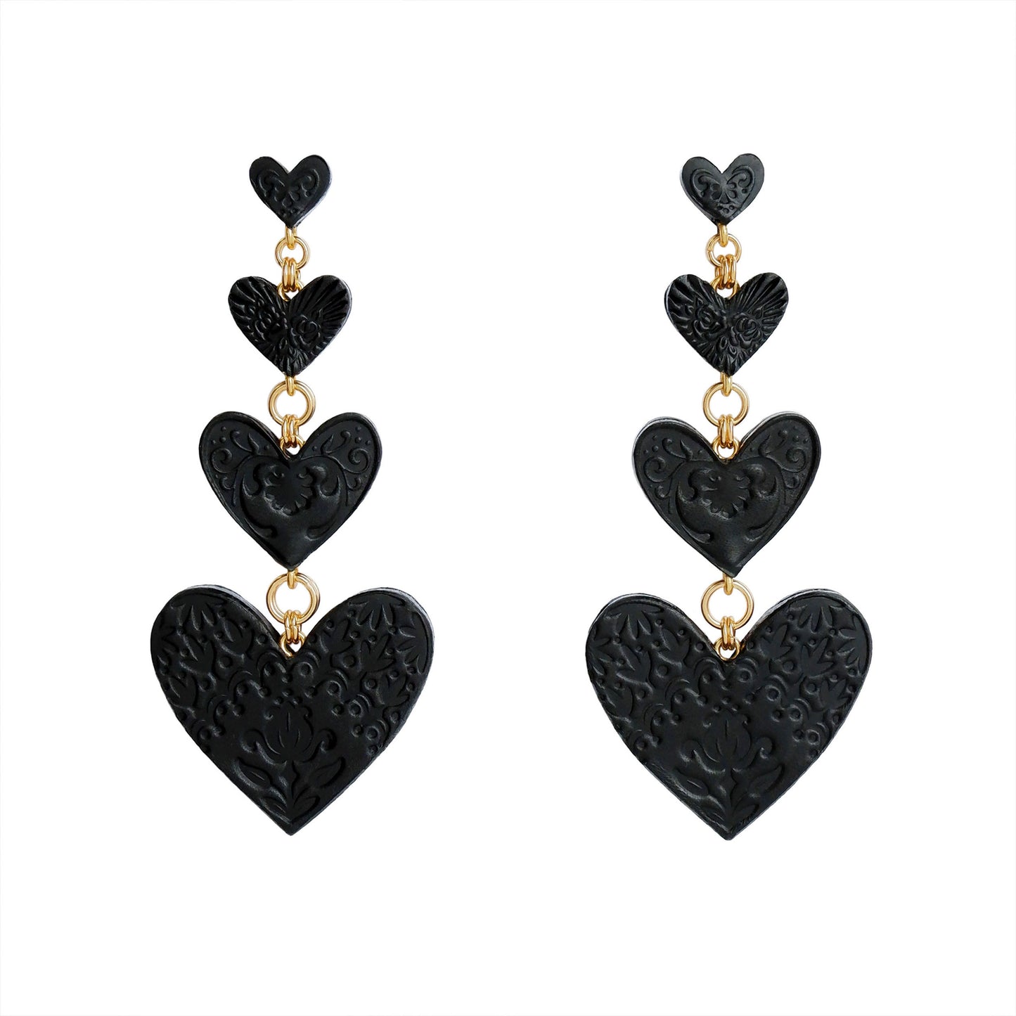 Chandelier Earrings, featuring 4 tiers of smooth Black Leather Hearts; each embossed with a different folk-art inspired floral design.