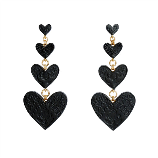 Chandelier Earrings, featuring 4 tiers of smooth Black Leather Hearts; each embossed with a different folk-art inspired floral design.