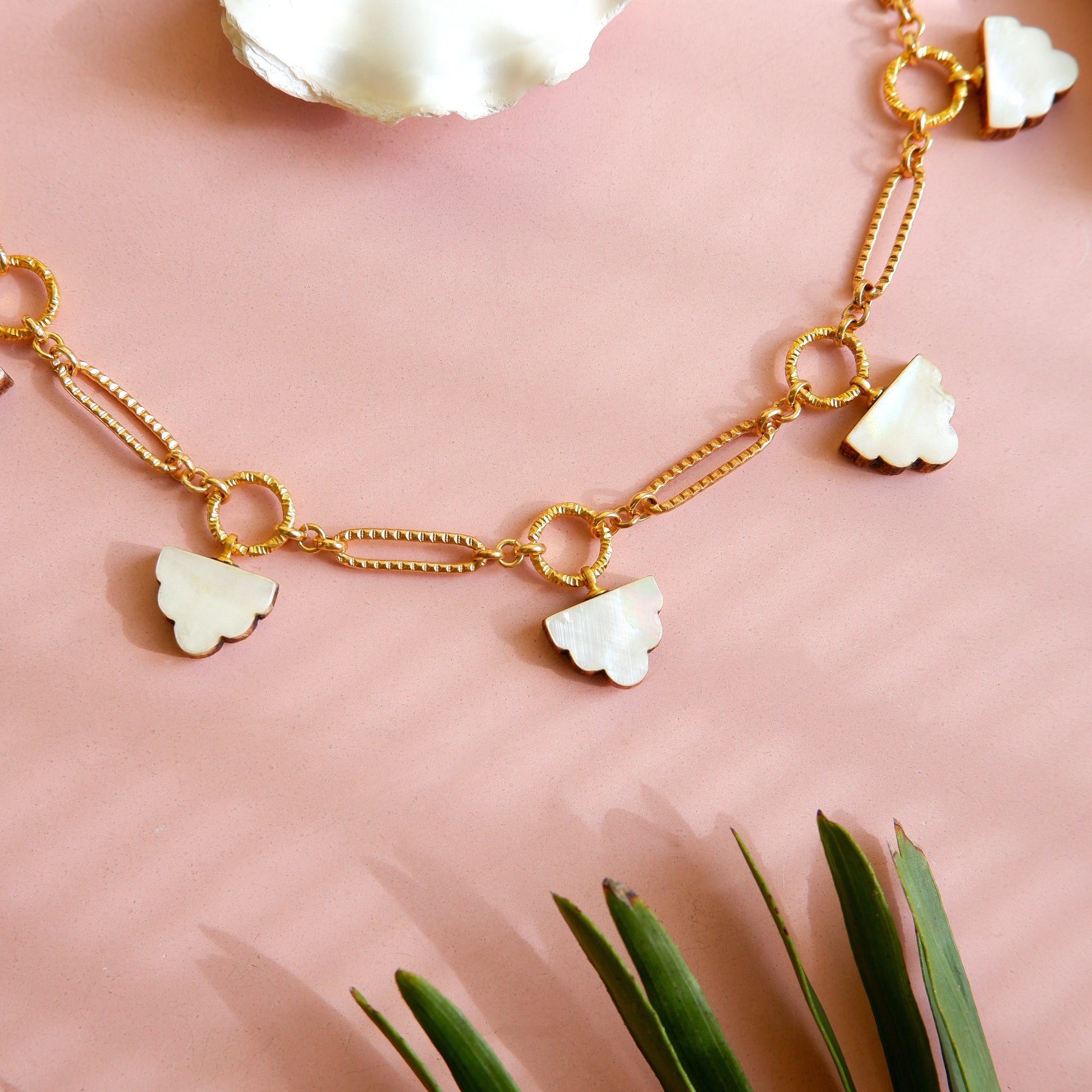 long-link gold chain charm necklace, with  deco cloud charms in mother of pearl