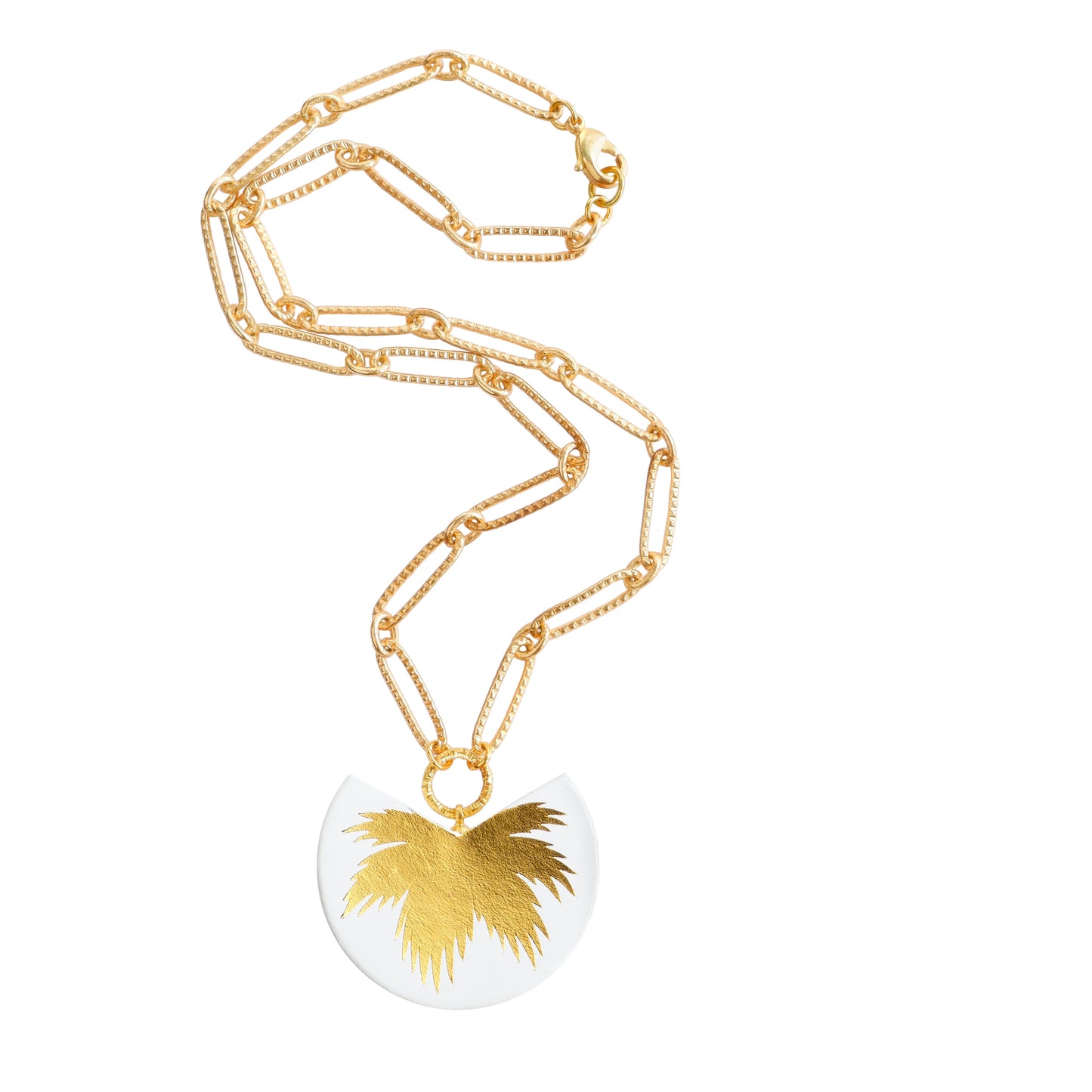 leather medallion pendant with gold palm tree print, on gold chain.