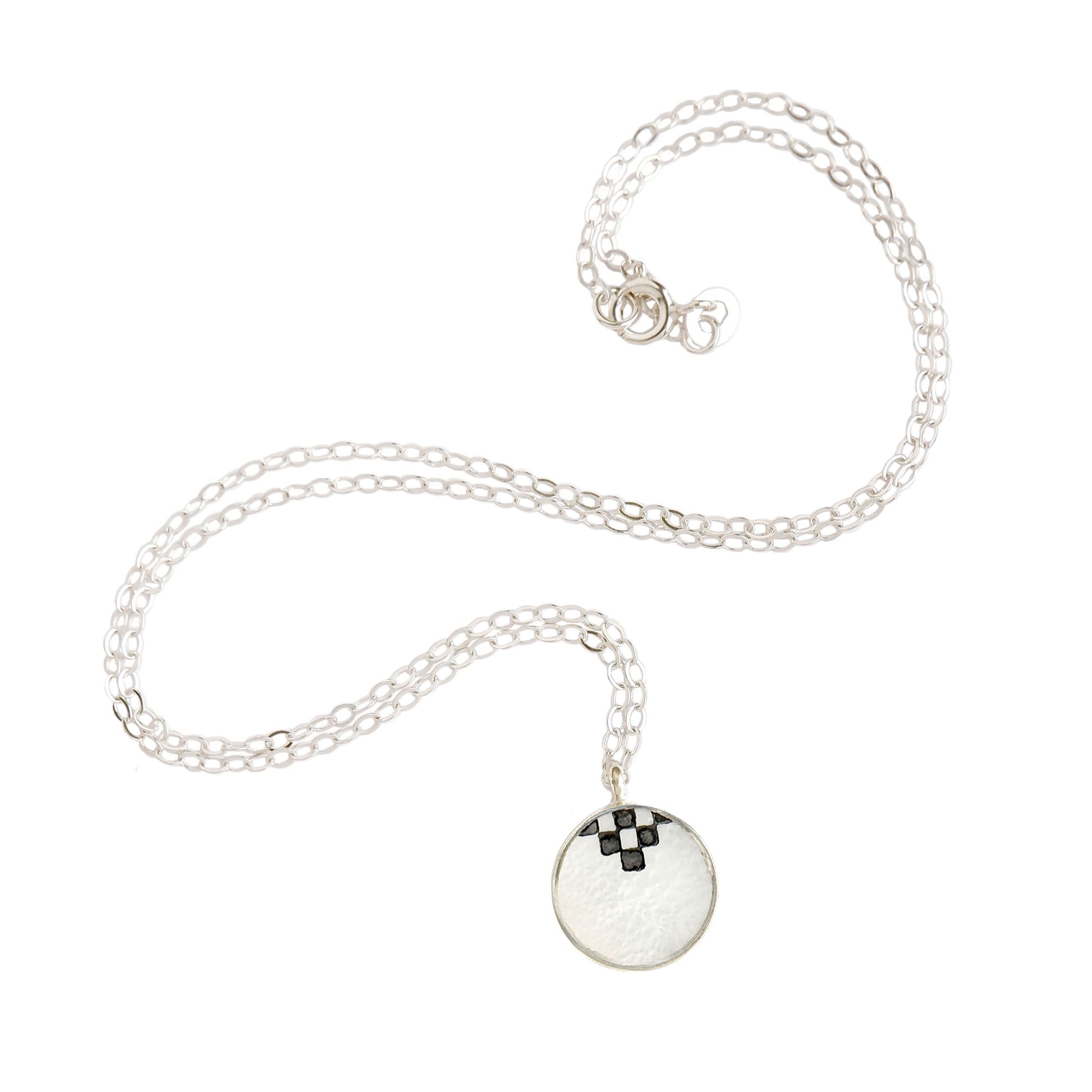 mother of pearl medallion pendant, engraved with chequerboard pattern, on fine sterling silver trace chain