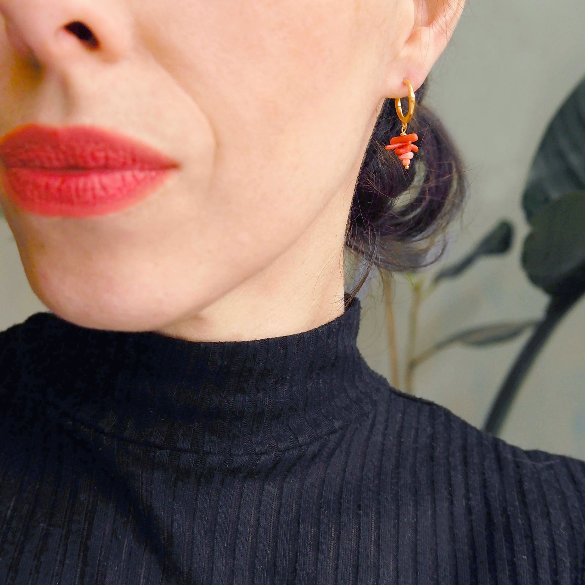 small gold bamboo hoops, with stacked coral branch bead charms, on person