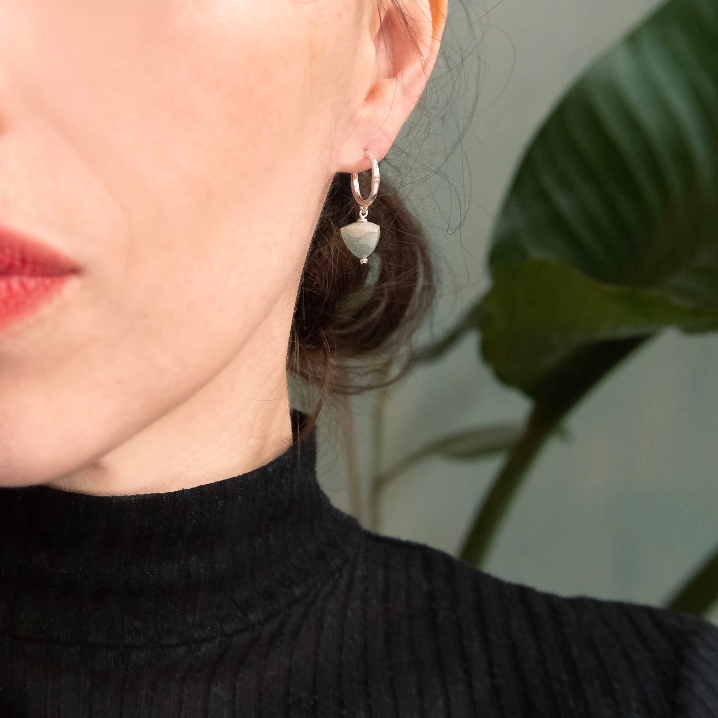 small gold bamboo hoops, with faceted trillion pyramid Aquamarine bead charm, on person