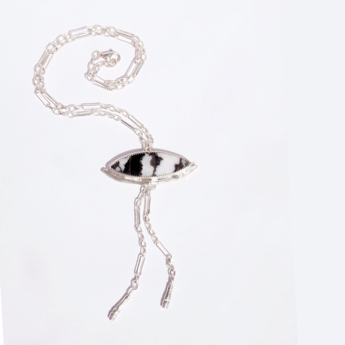 Silver Lariat style chain necklace, with a marquise cut black & white stripe Zebra Jasper gemstone pendant, framed  by a half halo of silver bamboo. 