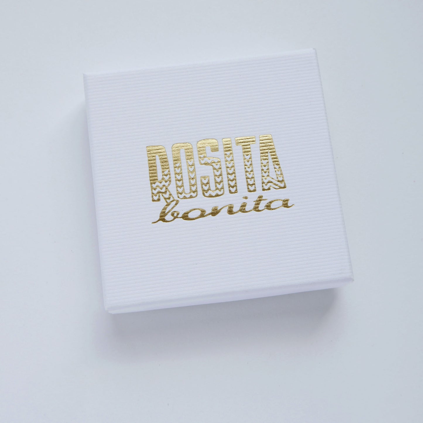 White pinstripe cardboard box with Rosita Bonita logo in gold