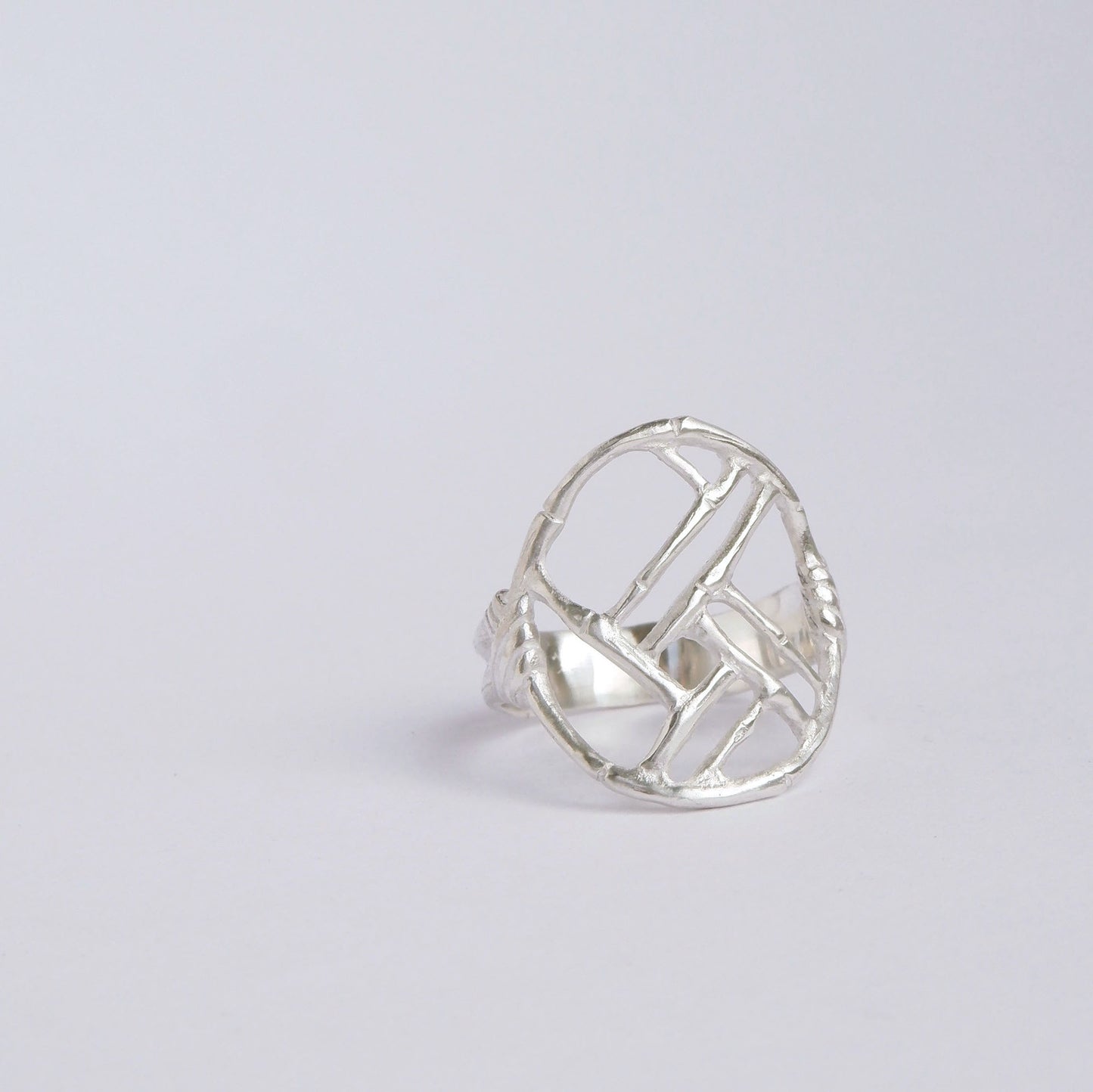 Sterling Silver ring with geometric open-work Bamboo Circle screen design, on a white background