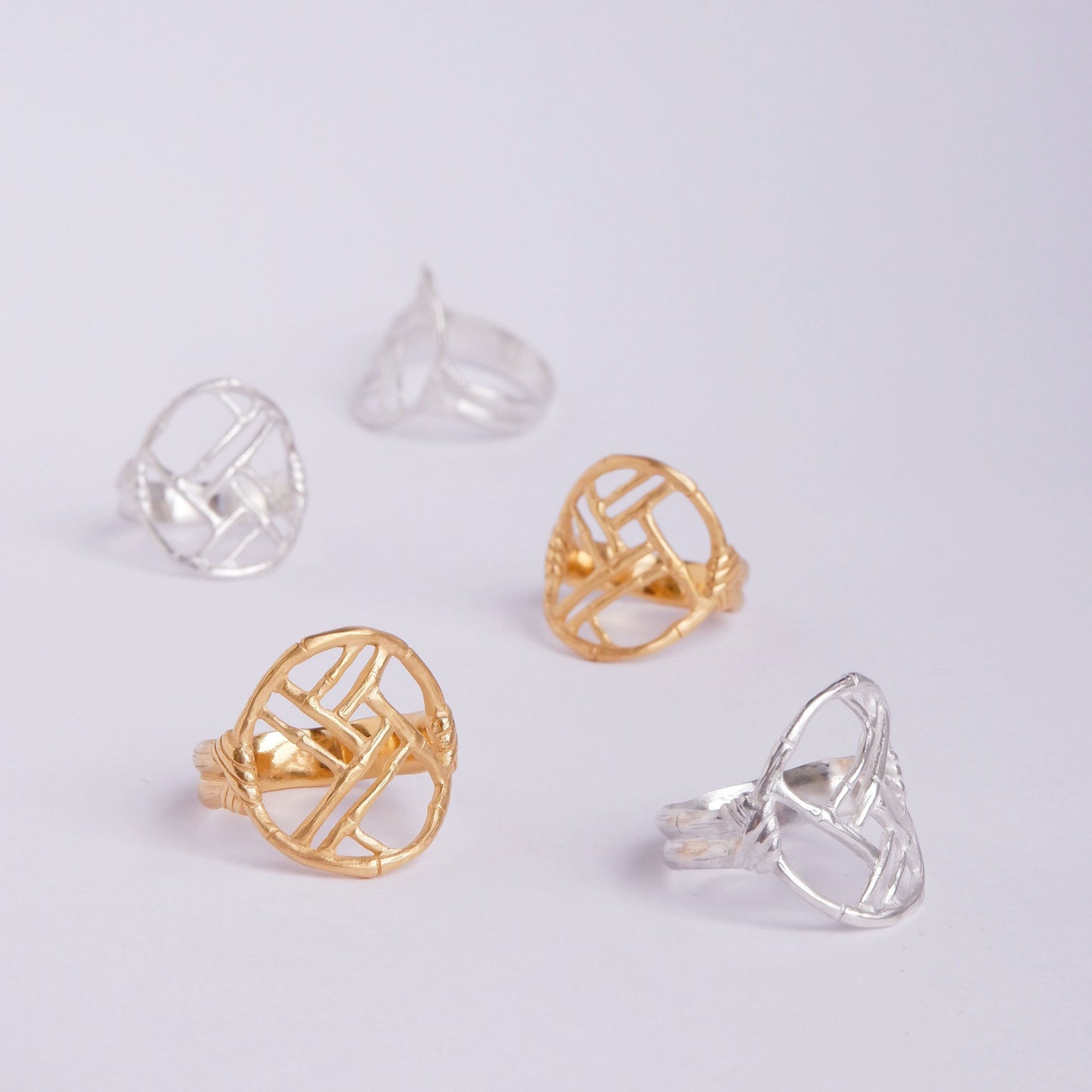 Gold Vermeil and Sterling Silver rings with geometric open-work Bamboo Circle screen design, on a white background