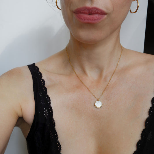 engraved mother of pearl medallion pendant, with white rabbit design, on fine gold vermeil trace chain, on model