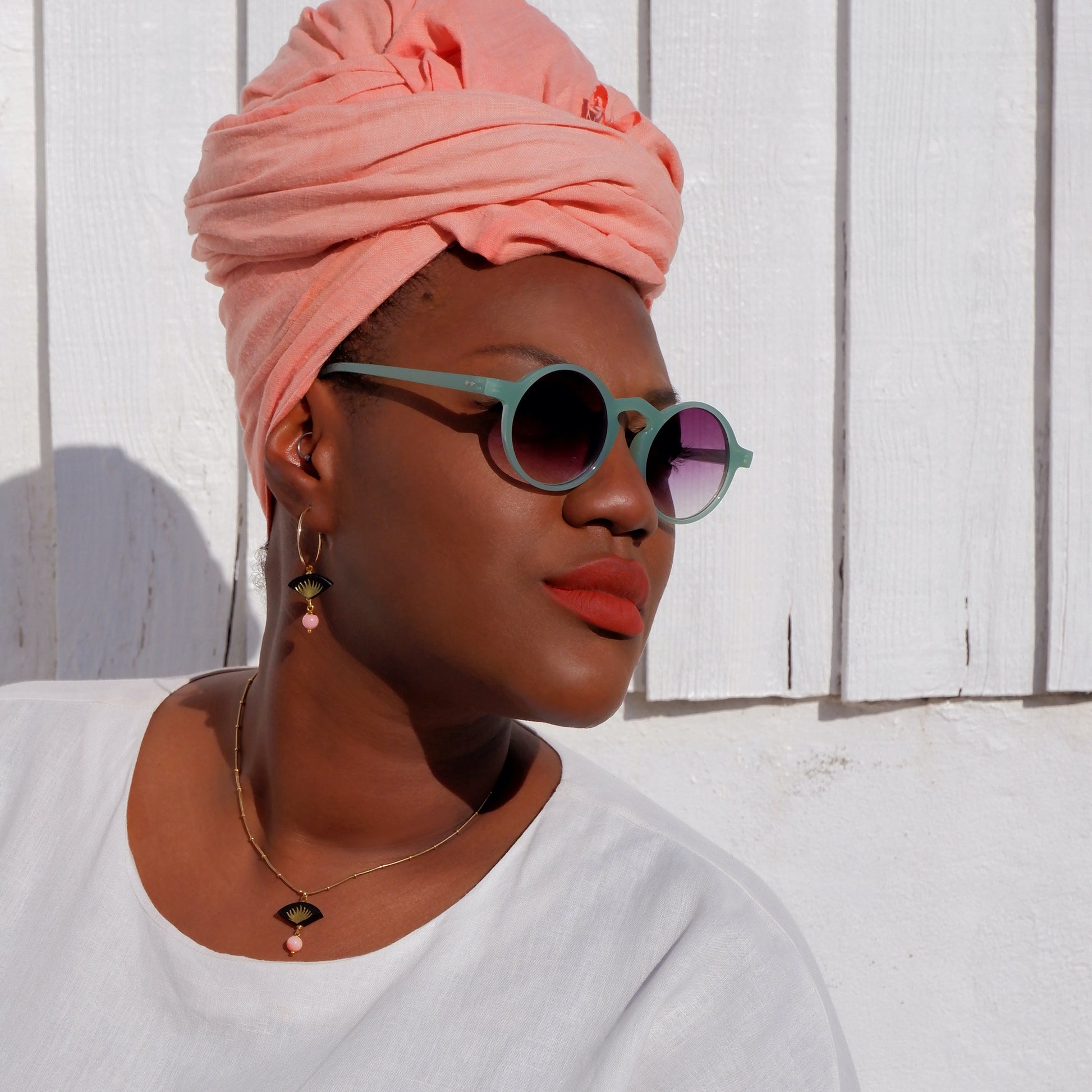 small leather fan earrings & pendant, with gold palm leaf print, and  dangling beads, on model