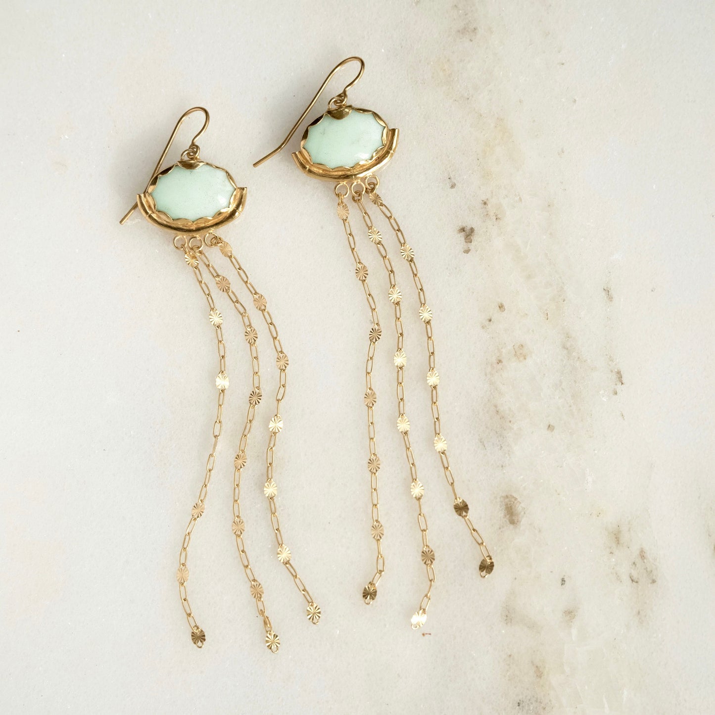 Gold vermeil and pastel mint gemstone chandelier earrings. milky Chrysoprase ovals, with subtle natural marbling, are encased in a pretty Gold Vermeil scalloped frame, gently resting in a slender bamboo "hammock", and adorned with the delicate starburst chain tassels.