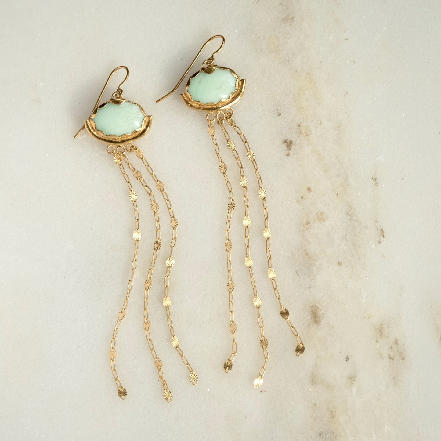 Gold vermeil and pastel mint gemstone chandelier earrings. milky Chrysoprase ovals, with subtle natural marbling, are encased in a pretty Gold Vermeil scalloped frame, gently resting in a slender bamboo "hammock", and adorned with the delicate starburst chain tassels.