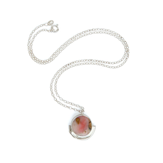 pink Opal gemstone circle pendant, framed by a silver bamboo style half moon halo mount, on a fine silver chain.