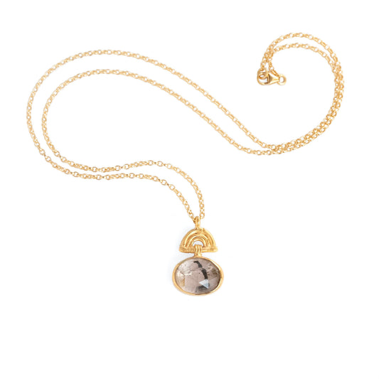 Pendant with oval Tourmalated Rose Quartz Gemstone hanging from a small gold Bamboo Arch, on fine gold chain. white background