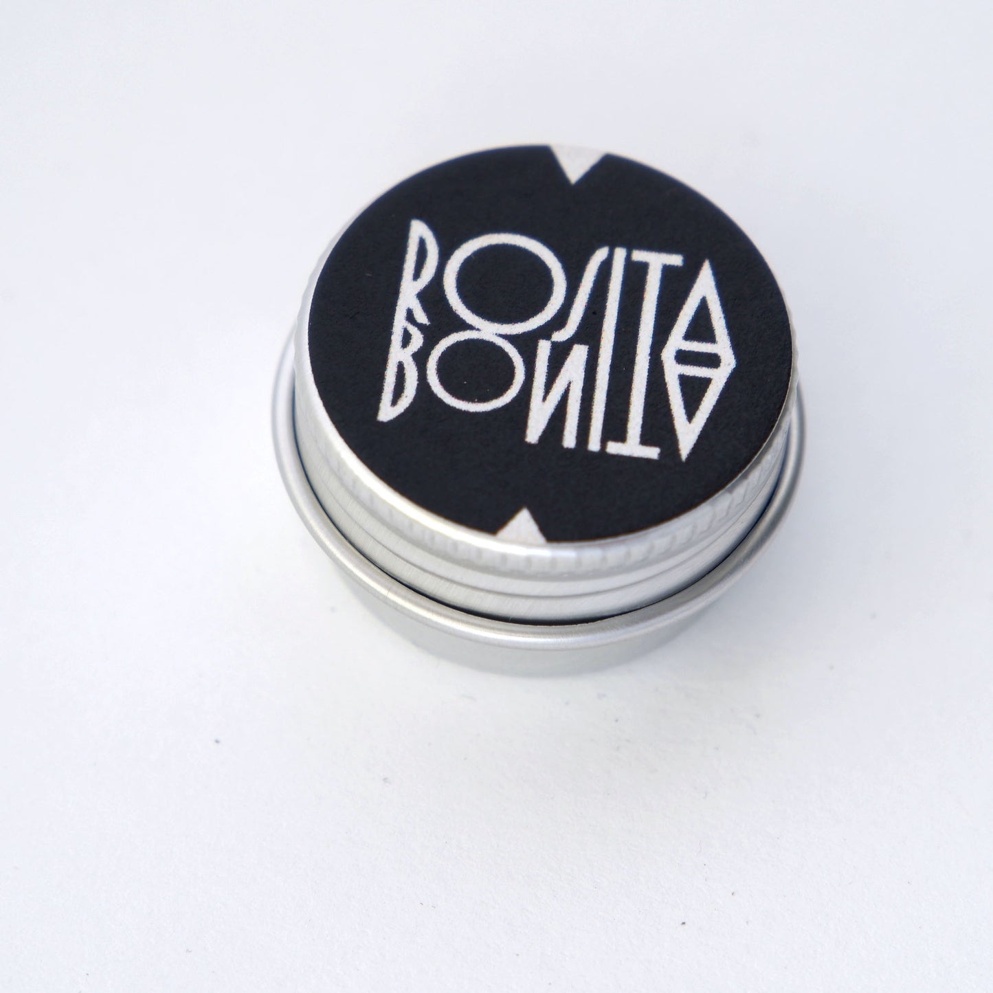 small silver tin with Rosita Bonita logo in Black & white