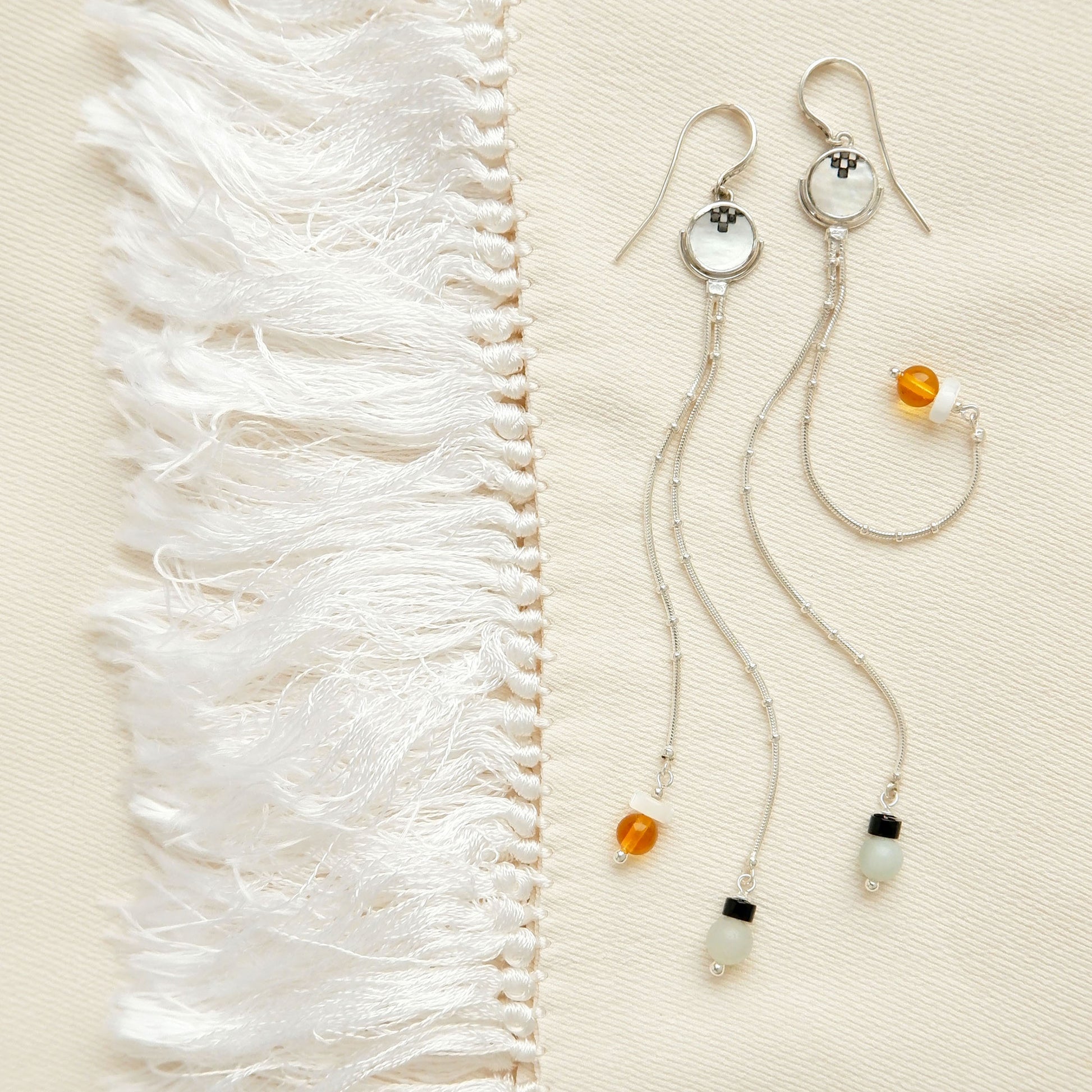 sterling silver beaded snake chain tassel earrings, with engraved mother of pearl full moon discs, and gemstone bead tips.