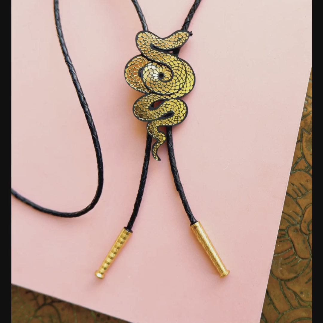 black & gold serpent bolo tie gif