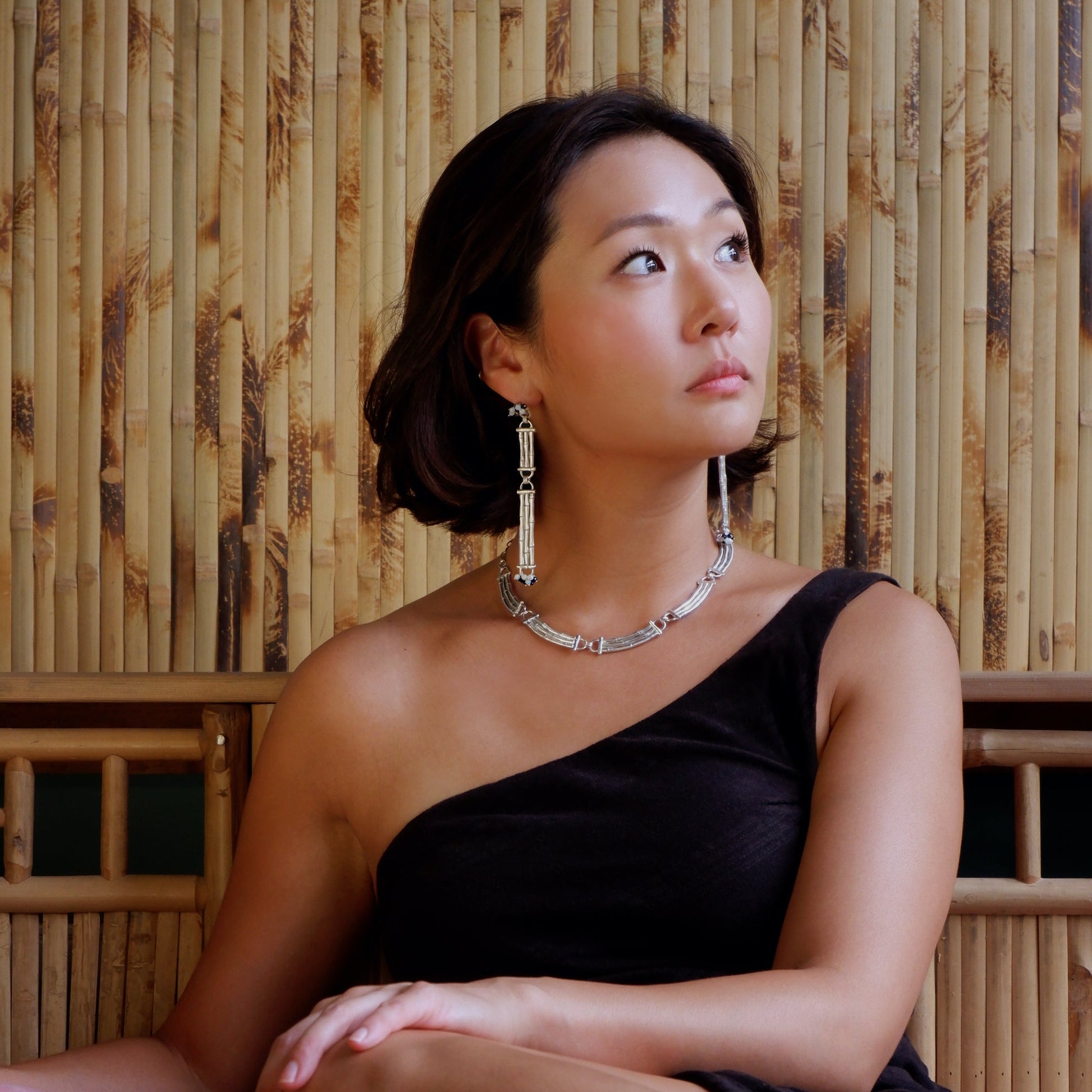 Sterling silver Bamboo Bar cocktail necklace & Earrings on model, bamboo backdrop