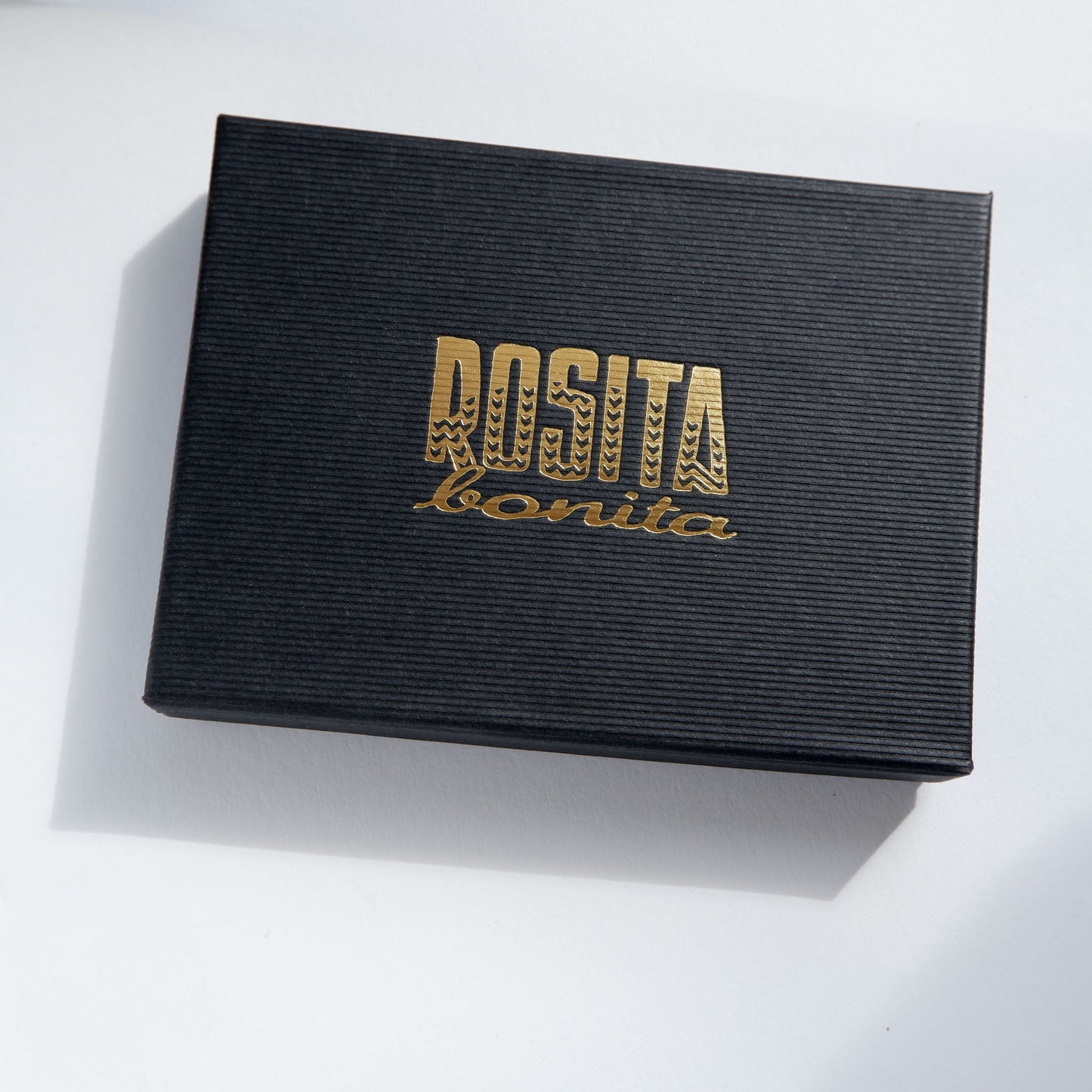 black pinstripe cardboard jewellery box with Rosita Bonita logo in gold